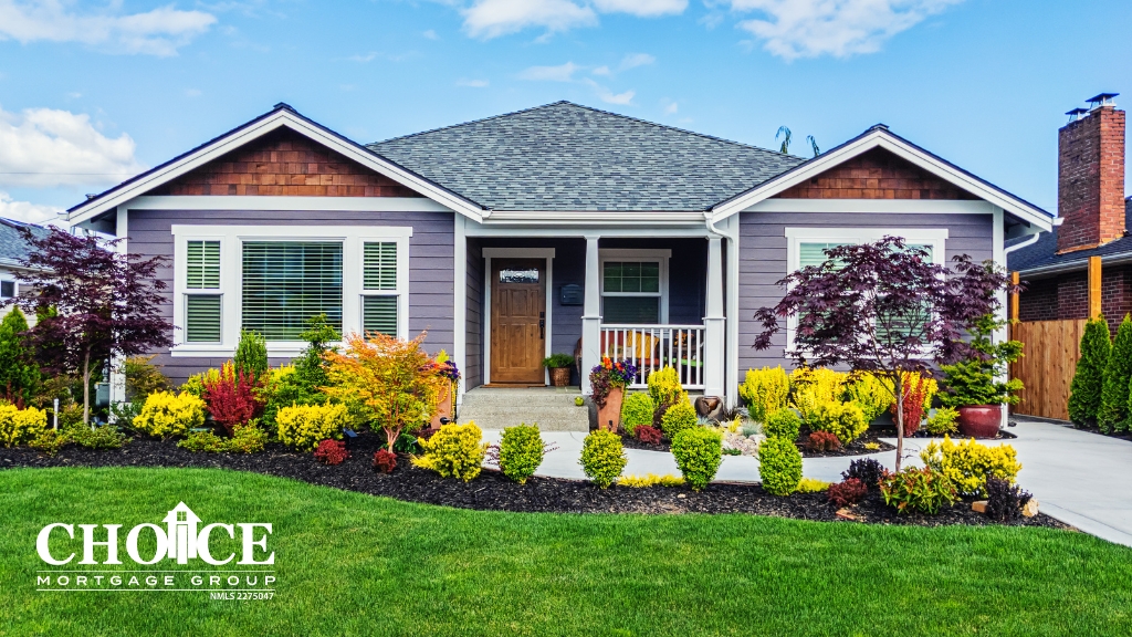 Purple home with cedar accents, black roof, nice landscape and green grass, with blue cloudy sky